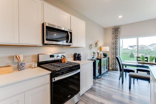 Built to both perform & impress, the home's kitchen offers a heartbeat to the place you'll spend the most time in. Photo of model home, color & options may vary.