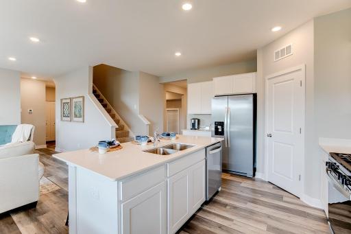 Kitchen has ample counter and cabinet space. The perfect space for making everyday meals or memorable special occasion dinners. Photo of model home, color & options may vary.