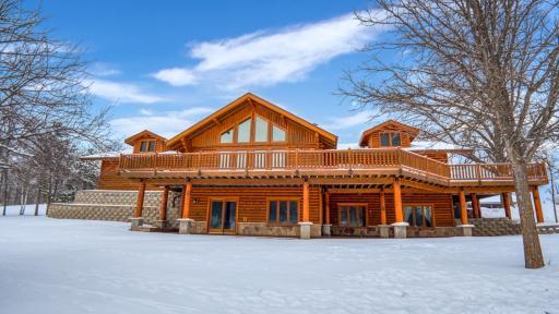 Exquisitive executive log home with massive wrap around deck.