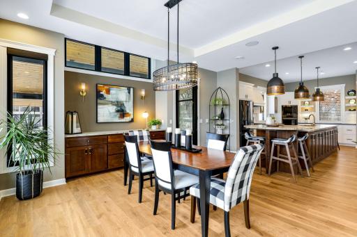 Dining room with custom built-in cabinets and door to sunroom