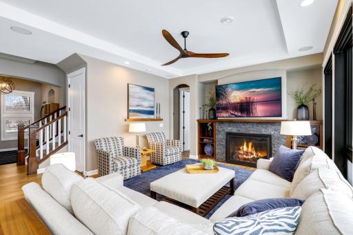 Main level great room features custom cherry built-ins and gas fireplace with stone surround