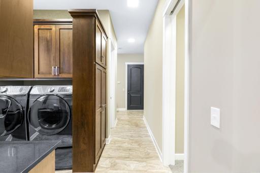 Hallway to laundry, mudroom and alternate entrance to the primary suite