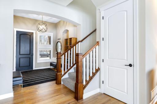 Main level foyer area with closet on the right and stairway to the upper level