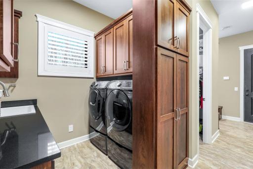 Hallway off foyer leads to the laundry room, mudroom, large walk-in mudroom closet and garage