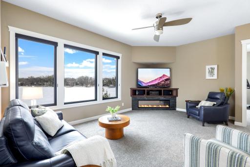 Upper level family room with electric fireplace and more lake views
