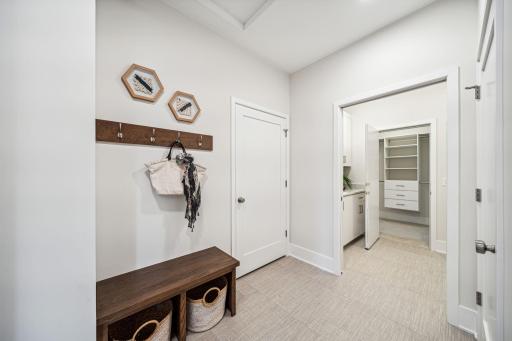 Mud room and laundry space is easily accessible from main part of house or primary suite.