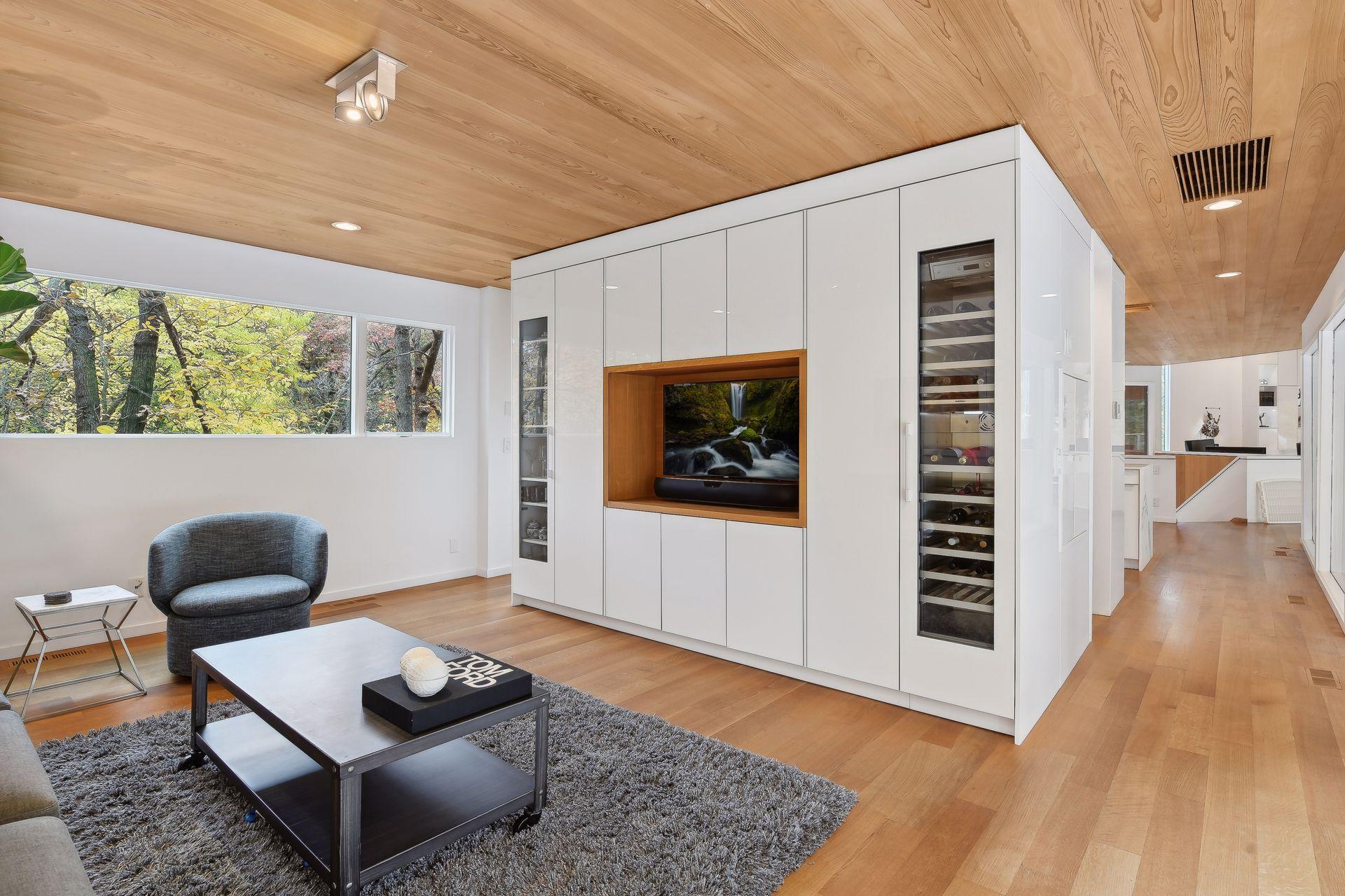 A wall of built ins to include a wine refrigerator and wifi systems contaiment center for all AV