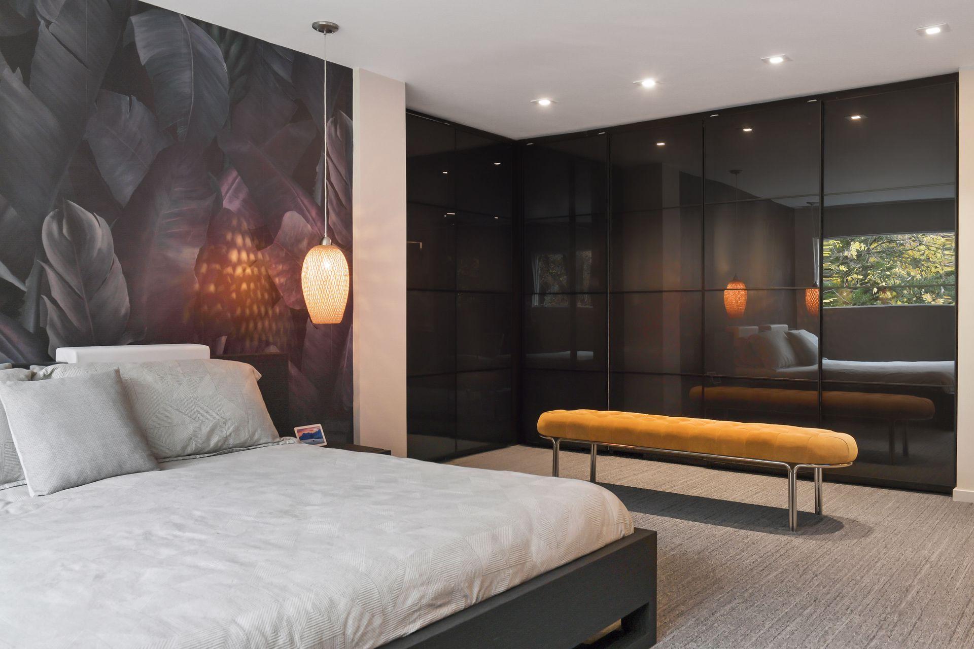 A wall of Floor to ceiling custom cabinetry and closet space