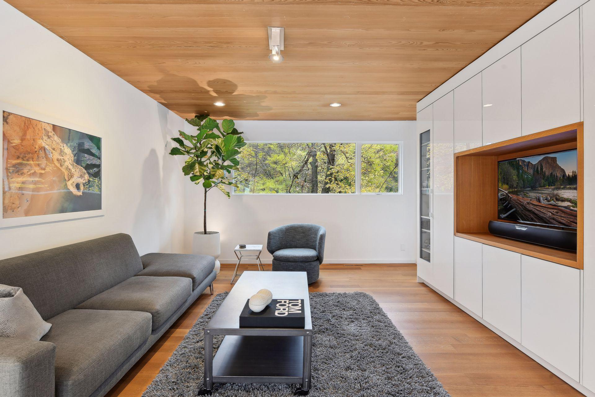 A fabulous upper level family room with tree top views and a spot to watch your favorite show