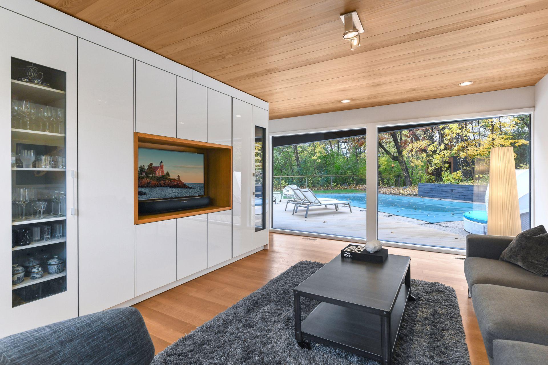 The floor to ceiling wall of cabinetry houses a wine refrigerator all with a view.