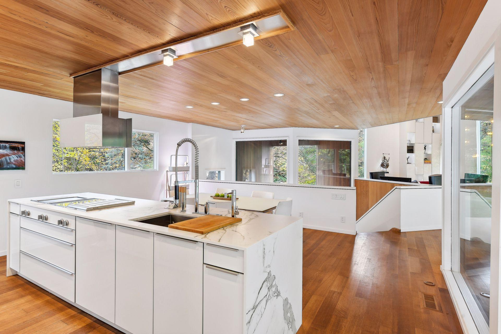 Leicht Cabinetry Acrylic High Gloss White from Germany reflects the outdoor scenery.