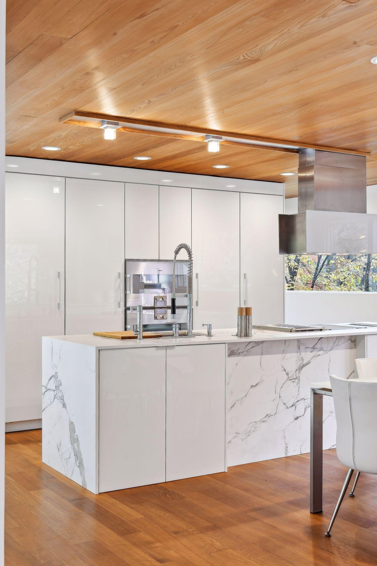 Deckton ultracompact countertop Aura White Calacatta Marble with a waterfull effect-stunning