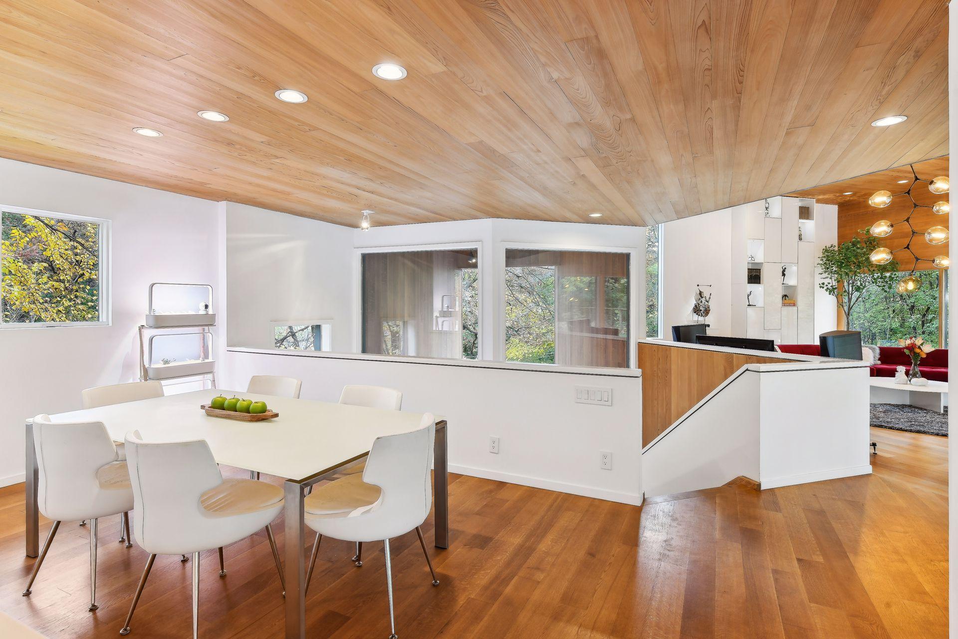 The solid hardwood ceilings span the entire space reaching into the open concept dining area