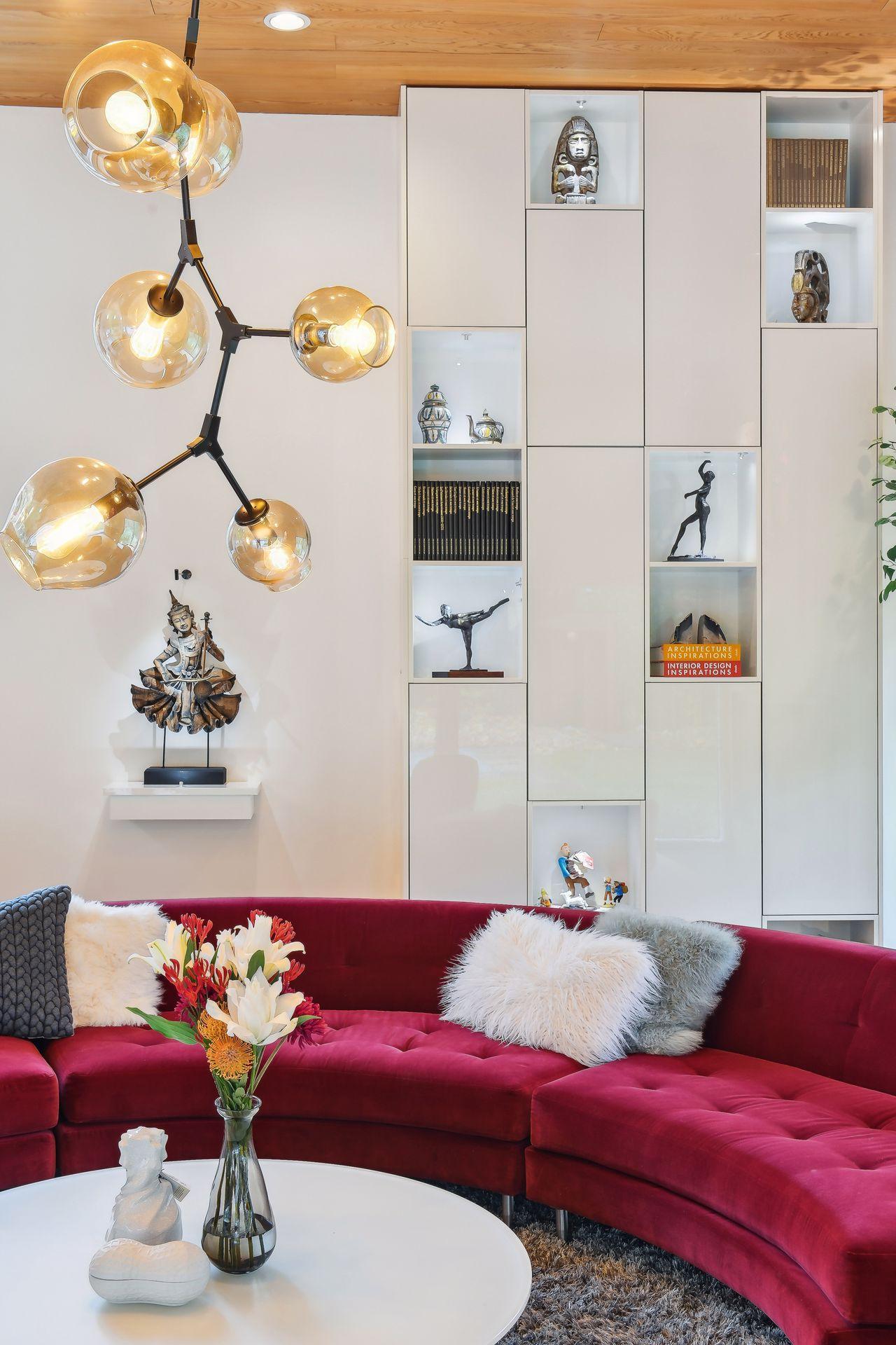 Artful custom cabinetry and stunning custom lighting ground this magnificent room