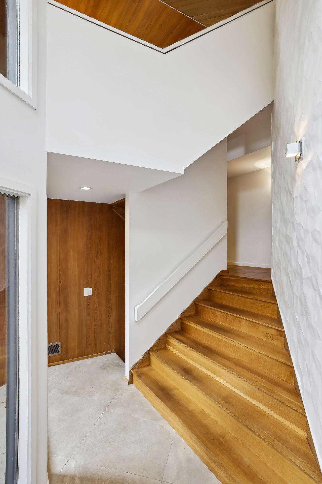 Solid wood floor offers warmth in contrast to the artful plaster