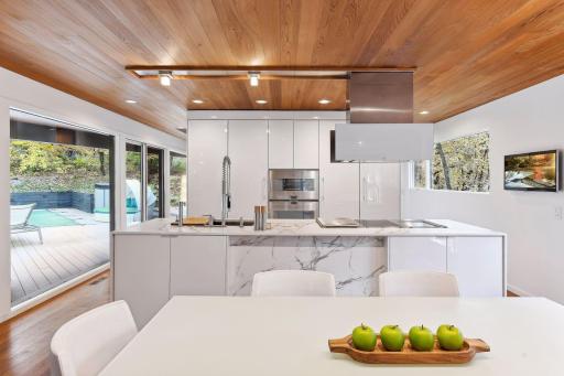A Culinary Enthusiast dream featuring top-of-the-line Gaggenau appliances. Subzero, Calcetta marble, Dornbracht fixtures and stunning Leight cabinetry with Acrylic high gloss white from Germany