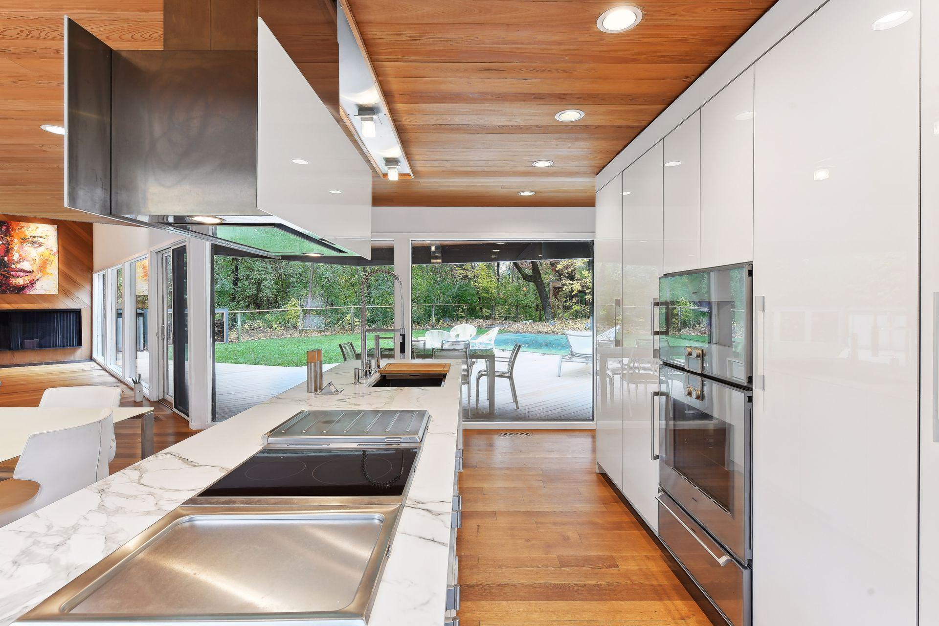 And connecting the chef's kitchen all overlooking the backside, woods, new outdoor living space and pool.