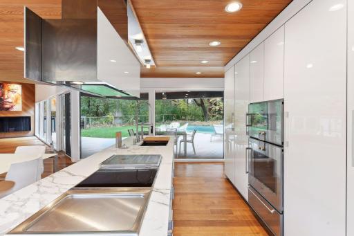 And connecting the chef's kitchen all overlooking the backside, woods, new outdoor living space and pool.