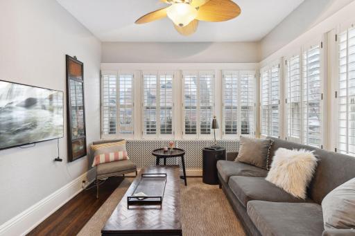 The four season sunroom features plantation shutters and hardwood floors. A cozy main level sitting room or office space with wonderful eastern and southern exposure.