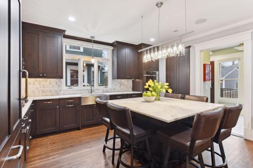 Gorgeous kitchen cabinetry and lighting. A discreet mudroom and powder room are located just off the kitchen at the back entrance.