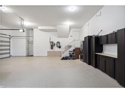 The 3-car Garage is completely finished with in-floor heating, new storage cabinets and epoxy-coated floors. Separate entrance to workshop (or 4th stall) not shown in this photo.