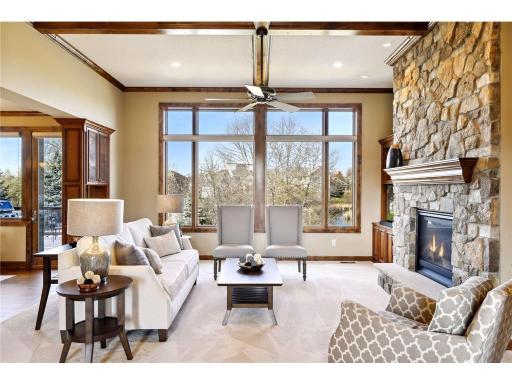 Great Room features gas fireplace, beautiful built-ins & floor-to-ceiling windows.