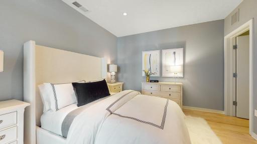 A wonderful aspect of unit 406's floor plan is that allows for one level living (if needed) including in-unit laundry. Unit 406 has two ensuite primary bedrooms! This is the main floor primary bedroom with private full bath (separate tub & shower).