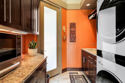 The main level laundry room offers storage cabinetry and is located right off the garage.