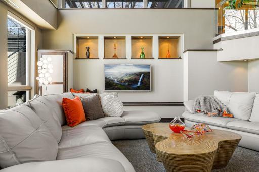 The great room is the heart of the home with a stunning wall of windows, lighted art alcoves and built-ins, an expansive technology storage center and a charming hidden kids nook.