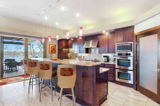 The chef's kitchen features a double oven, 2 dishwashers, a massive fridge, walk-in pantry, spacious eat-in dining space and an adjoining formal dining room.