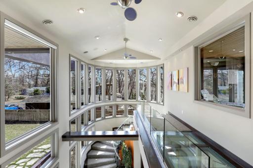 Walk over the unique glass hallway above the foyer space.