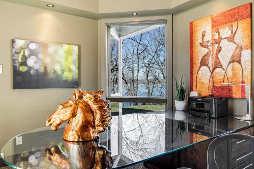 The dual office set-up features large windows, a rounded tray ceiling and built-ins.