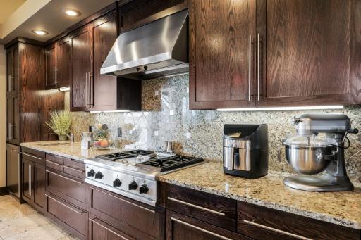 The chef's kitchen features a double oven, 2 dishwashers, a massive fridge, walk-in pantry, spacious eat-in dining space and an adjoining formal dining room.