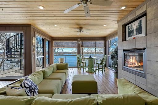 The sunroom has fresh paint and refinished flooring, a gas-burning fireplace and leads up to the incredible, rooftop deck.