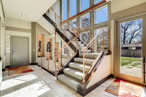 Floor to ceiling windows provide natural light to every part of the home including hallways and staircases.