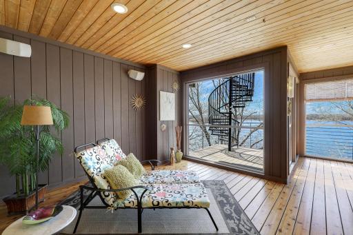 The sunroom has fresh paint and refinished flooring, a gas-burning fireplace and leads up to the incredible, rooftop deck.