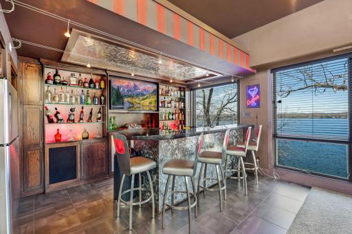 Enjoy the luxurious bar/entertainment area complete with a wine fridge, dishwasher, trash compacter and garbage disposal.