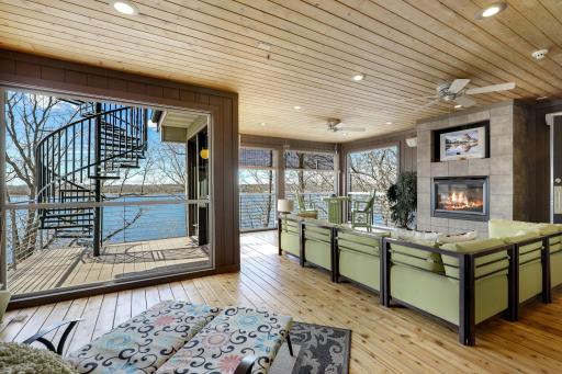 The sunroom has fresh paint and refinished flooring, a gas-burning fireplace and leads up to the incredible, rooftop deck.