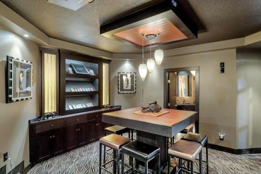 The custom designed theater room with game table and candy display shelving.