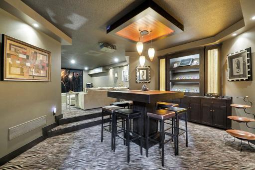 The custom designed theater room with game table and candy display shelving.