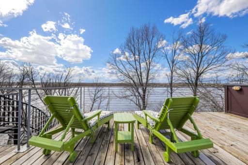 A spiral staircase leads up to the rooftop deck with breathtaking lake and sunset views.