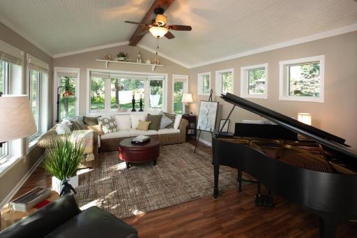 Beautiful sunroom with vaulted ceilings and lots of windows to enjoy those views!