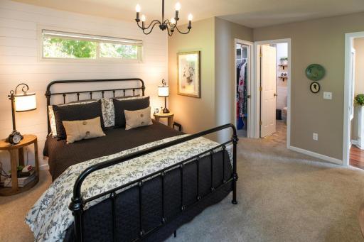 Here is your main floor primary bedroom...full primary bath and walk in closet with pocket doors.