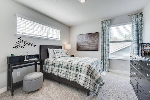 One of three additional bedrooms - all big enough to accommodate whatever setup you would like! (Model home, colors will vary)