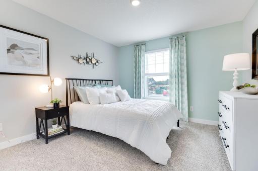 One of three additional bedrooms - one in each corner of the upstairs, providing separation while all being together on the same level. (Model home, colors will vary)
