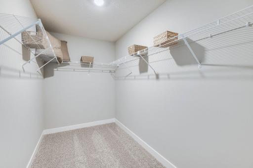 This walk-in closet in the primary bedroom can handle your clothes and then some! (Model home, colors will vary)
