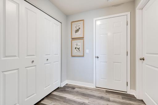 Mudroom as you enter from your garage. Coat closet to the left, storage space to the right. (Model home, colors will vary)