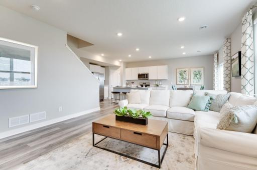This spacious family gathering area seamlessly connects to the kitchen area, perfect for entertaining. It also features many large windows providing warm natural light. *Pictures are of a model home, actual colors and finishes may vary.