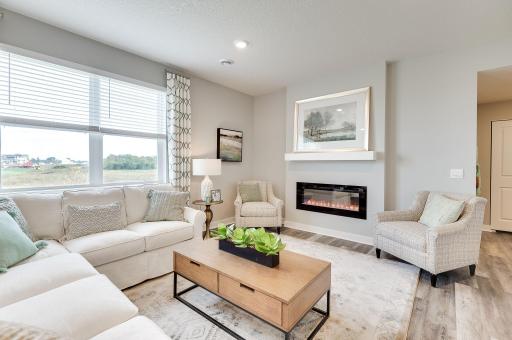 Light and bright with modern electric fireplace, this living room is a welcoming space for all. *Pictures are of a model home, actual colors and finishes may vary.