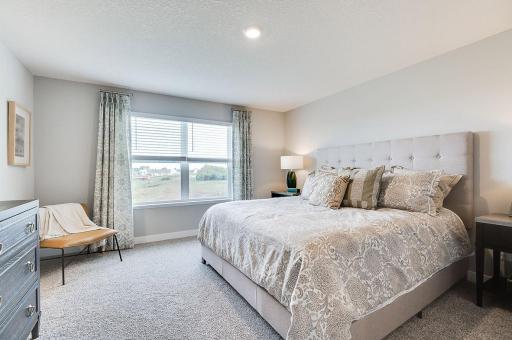 Spacious and modern would best describe this primary suite. This suite includes private access to an ensuite bath and walk-in closet. *Pictures are of a model home, actual colors and finishes may vary.
